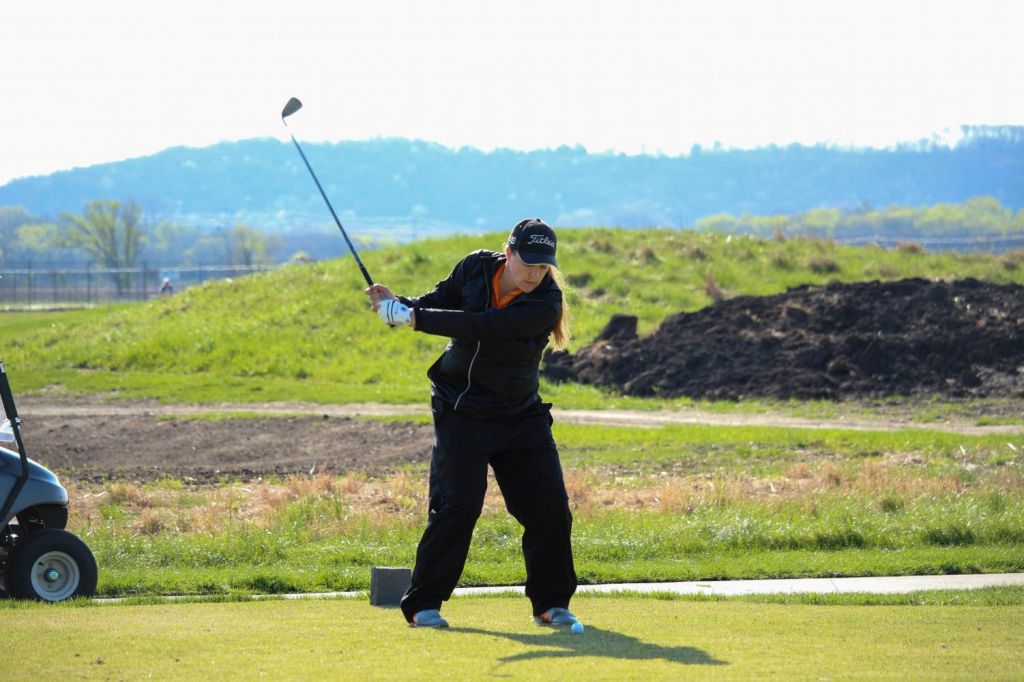 Sophomore Annie Raybourn keeps her eye focused on the ball during her backswing. Raybourn tied for ninth at the Graceland Spring Invitational on March 24