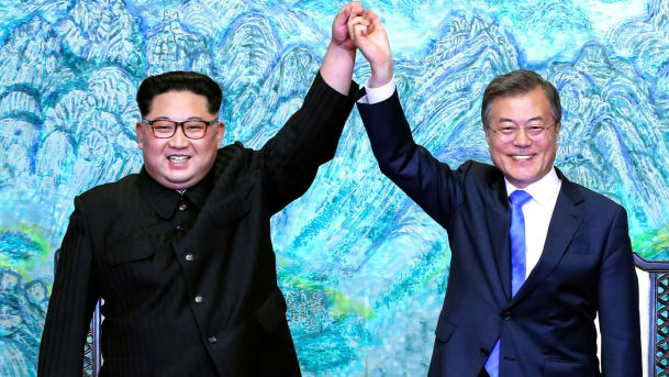 North Korean leader Kim Jong Un left and South Korean President Moon Jae-in raise their hands after signing a joint statement at the border village of Panmunjom in the Demilitarized Zone