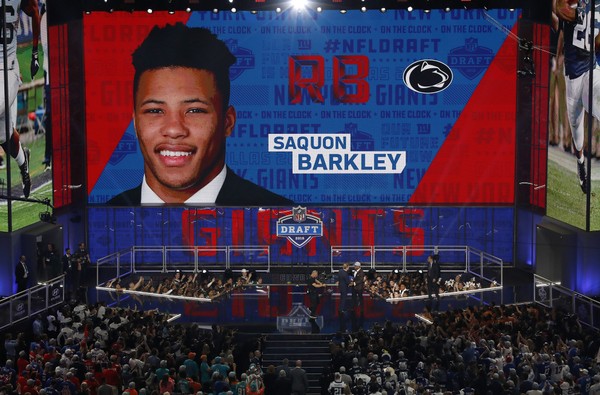 Penn State's Saquon Barkley greets commissioner Roger Goodell on the stage after being selected by the New York Giants during the first round of the NFL football draft Thursday