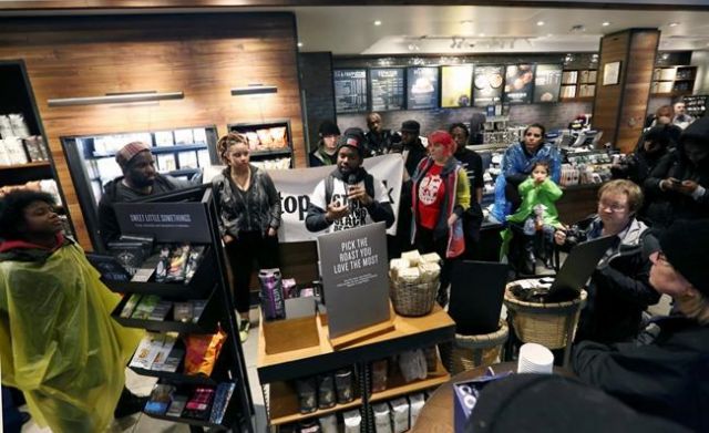 Demonstrators occupy the Starbucks that has become the center of protests Monday