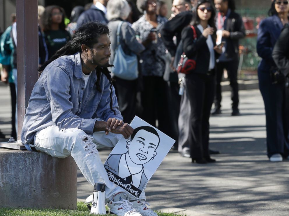 Steven Ash holds drawing of police shooting victim Stephon Clark as he waits to enter the Bayside of South Sacramento Church known as BOSS Church for Clarks,Thursday