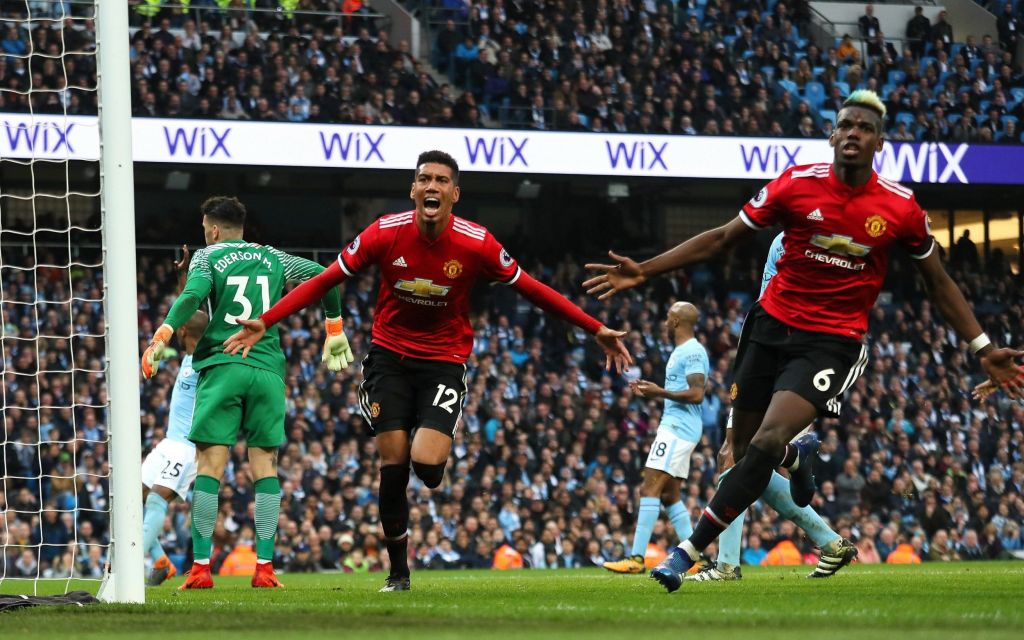 Chris Smalling and Paul Pogba celebrate scoring at the Etihad