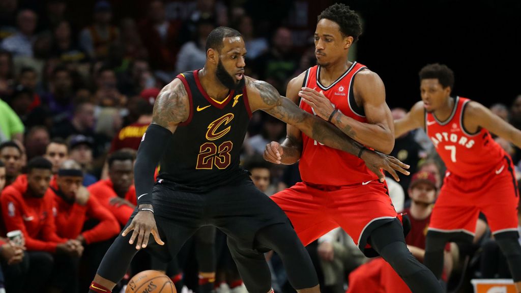 Cavs forward Le Bron James defended by Raptors guard De Mar DeRozan