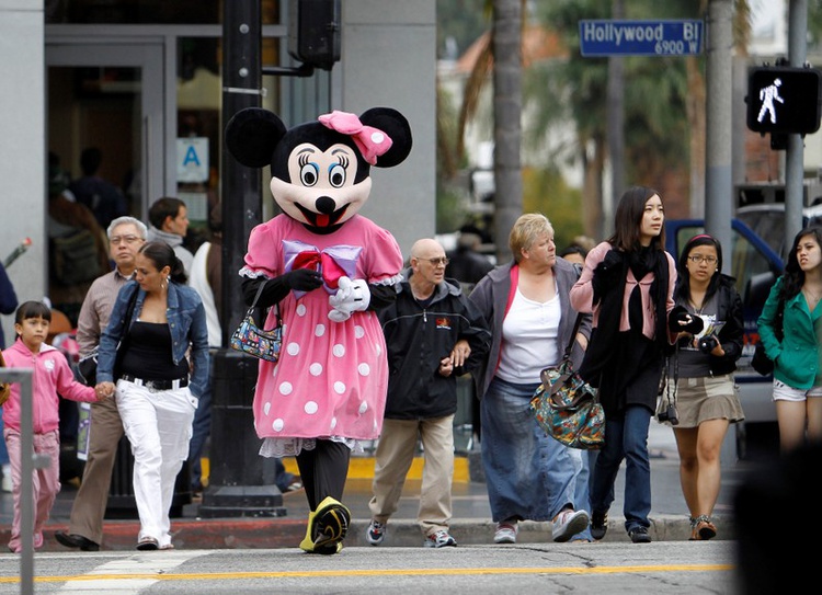 Walt Disney character Minnie Mouse crosses the street in Hollywood California