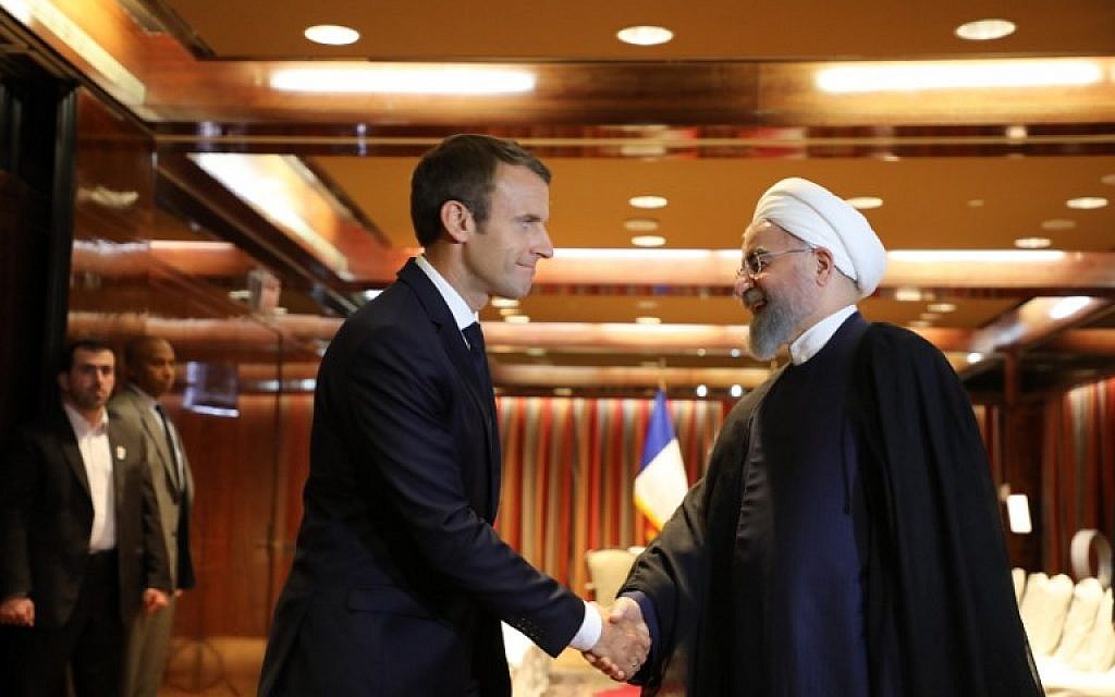 France's President Emmanuel Macron greets Iranian President Hassan Rouhani at the Millennium Hotel in New York