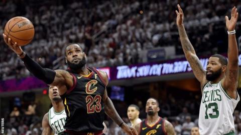 Boston Celtics Marcus Morris attempts to block Le Bron James of Cleveland Cavaliers