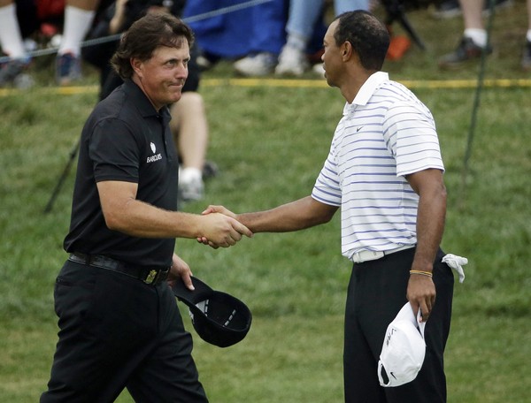 Phil Mickelson left shakes hands with Tiger Woods after the second round of the PGA Championship golf tournament at Valhalla Golf Club in Louisville Kentucky