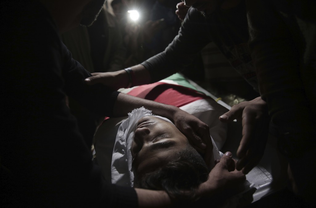 Relatives of 15 year-old Palestinian Jamal Afaneh mourn over his body at the family house during his funeral in Rafah refugee camp southern Gaza Stri