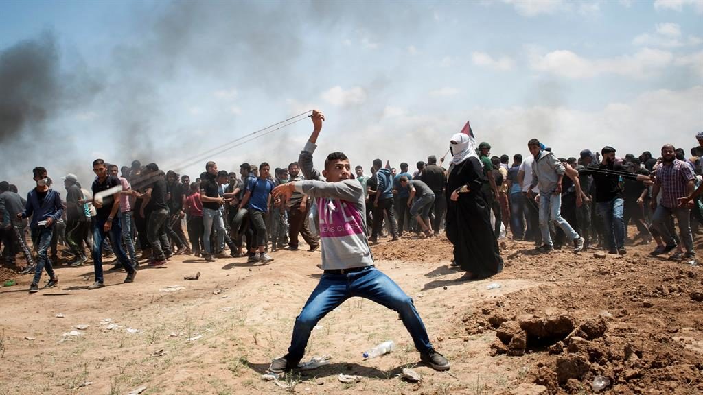 Anger A Palestinian uses a slingshot to hurl a stone during the protests