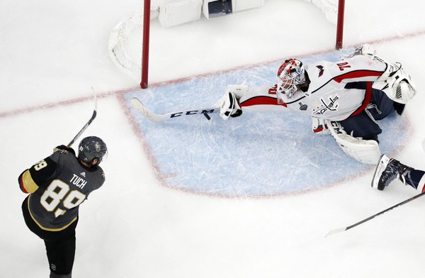 Washington Capitals goaltender Braden Holtby right makes a stick save on shot by Vegas Golden Knights right wing Alex Tuch a Baldwinsville native during the third period in Game 2 of the NHL hockey Stanley Cup Finals on Wednesday