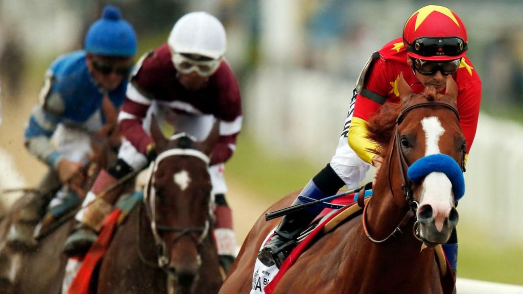 Justify, with jockey Mike Smith up leads the pack as it approaches the first turn during the 150th running of the Belmont Stakes horse race Saturday