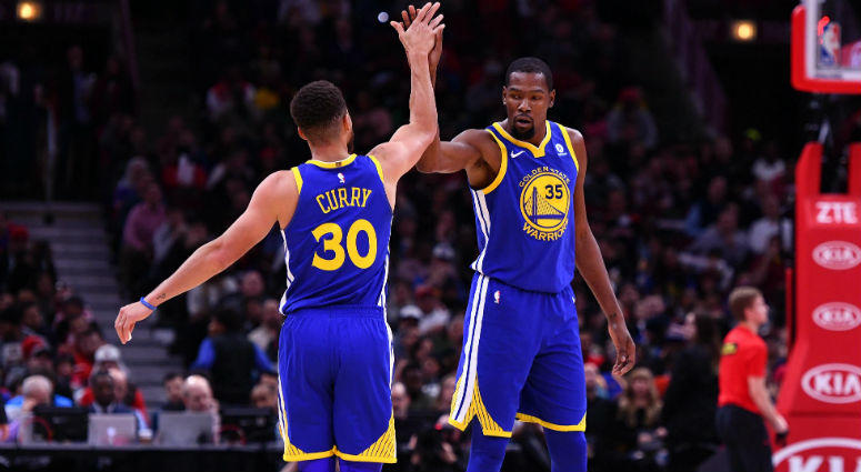 Stephen Curry reacts with Kevin Durant after making a three point basket against the Chicago Bulls during the second half at the United Center in Chicago