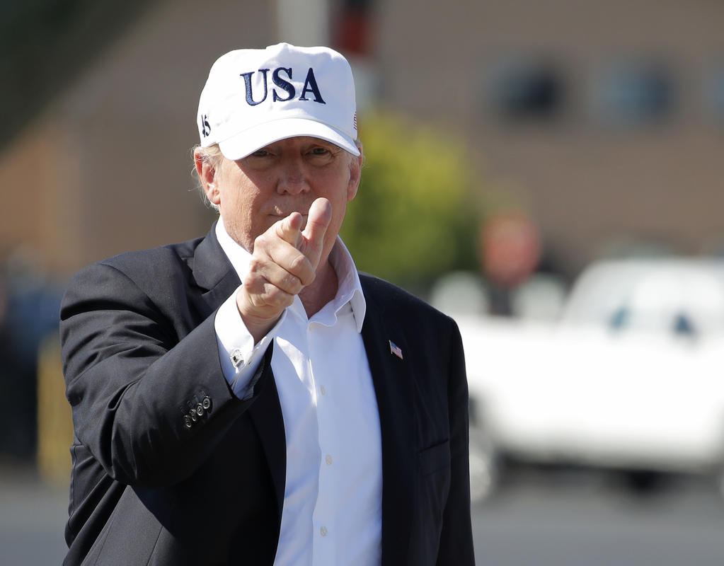 President Donald Trump points before boarding Air Force One at Morristown Municipal Airport in Morristown N.J. Sunday