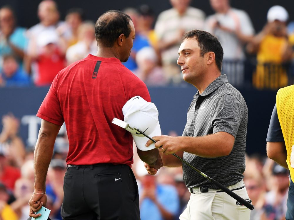 Francesco Molinari of Italy is congratulated by Tiger Woods of the United States after a birdie on the 18th hole during the final round of the 147th Open Championship at Carnoustie Golf Club