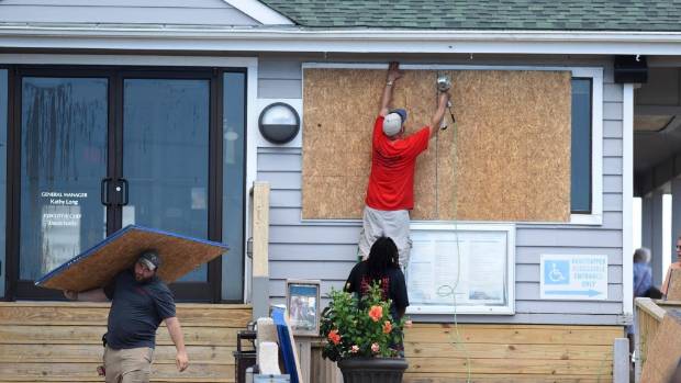 Crews board up the Oceanic restaurant in Wrightsville Beach North Carolina in preparation for Hurricane Florence