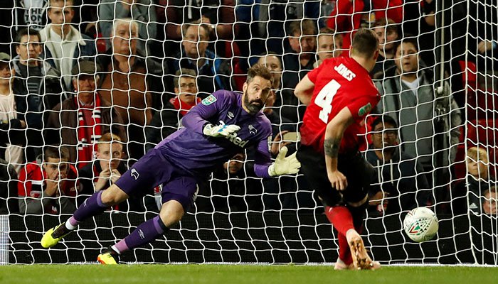 Manchester United´s Phil Jones has a penalty saved by Derby County´s Scott Carson during the shootout