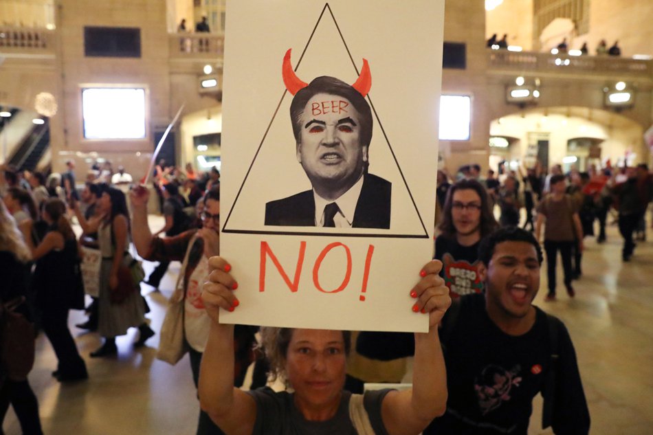 A demonstrator holds a sign during a protest and march against the U.S. Supreme Court nominee Brett Kavanaugh in New York City. Reuters