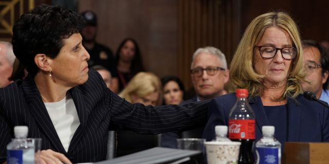 Attorney Debra Katz puts her hand on Christine Blasey Ford as she testifies before the Senate Judiciary Committee