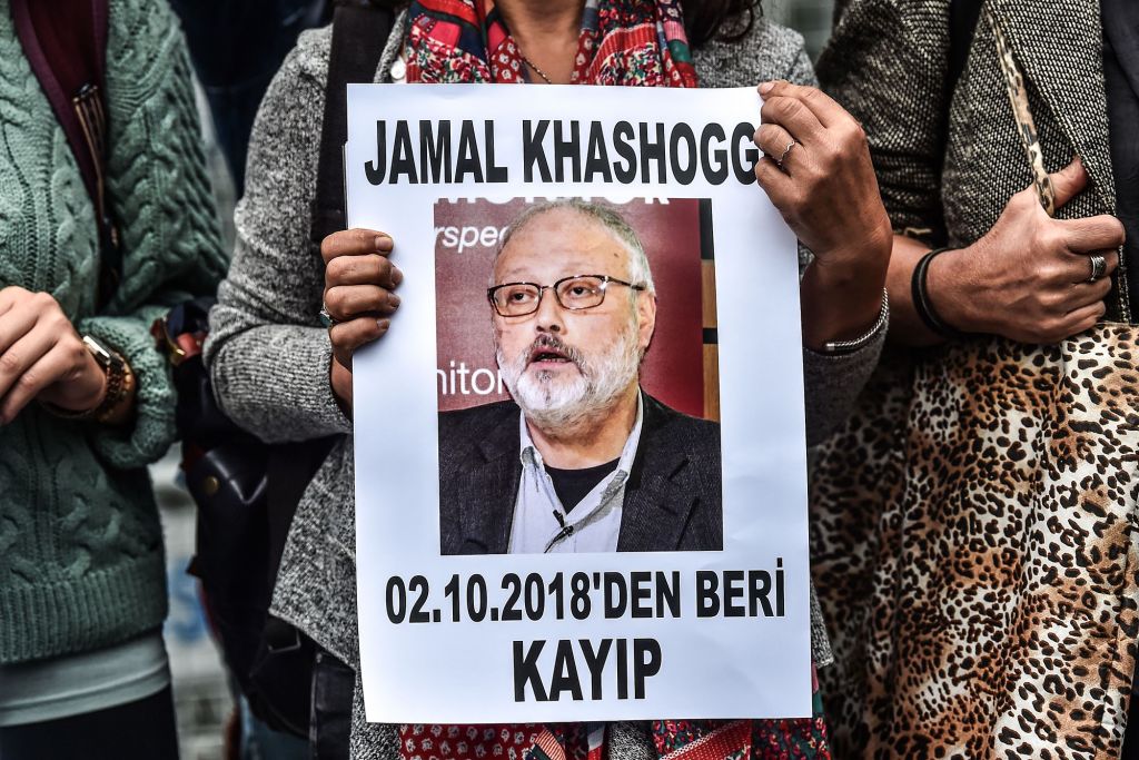 A woman holds a portrait of missing journalist and Riyadh critic Jamal Khashoggi