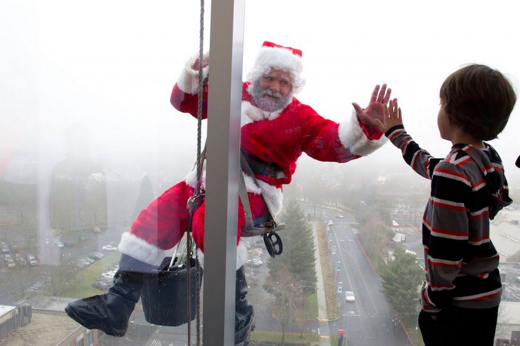 Santa cleaning windows to cheer the sick kids