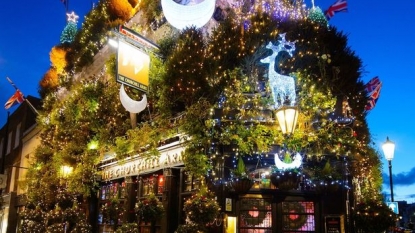 Watch a London’s pub, covered with lots of Christmas tress