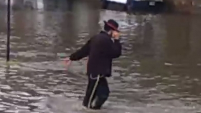 Man doing moonwalking on flooded road