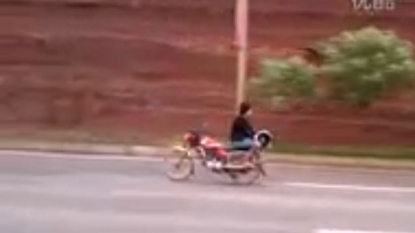 Motorcyclist riding the bike by sitting in backward direction