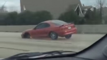 Car spotted on highway running on only three wheels