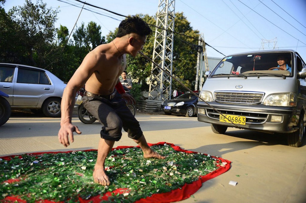 Man barefoot on broken glass pulling a 3-ton truck just using his teeth in attempt to create a world record