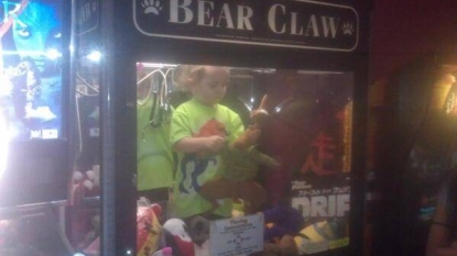 Three year old kid found inside claw machine playing with toys