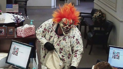 A clown and monkey is being searched by police after a bank robbery