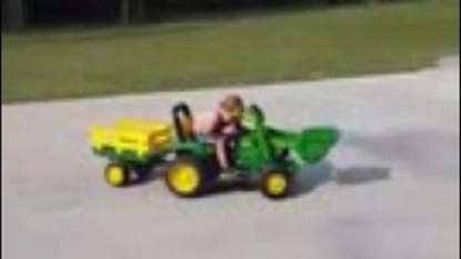 Kid as a truck driver fallen asleep while driving on toy truck