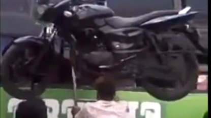 Man climbs on ladder with a BIKE on his head