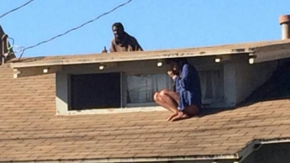 Terrifying moment when a woman hides herself on roof because of an intruder