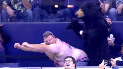 A man cheering up his home team in ice hockey with his bizarre dance skills