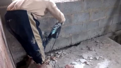 Moment when a worker fallen from concrete surface after he drilled it off