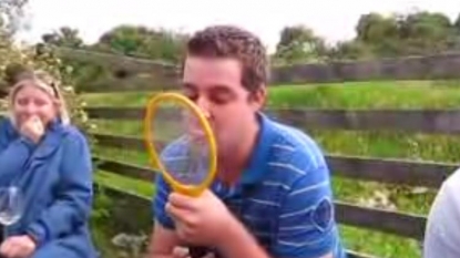 Friends dare each other to lick the electronic fly-swatter