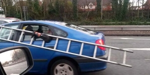 Car passengers spotted travelling with a huge metal ladder at the speed of 50mph on busy road