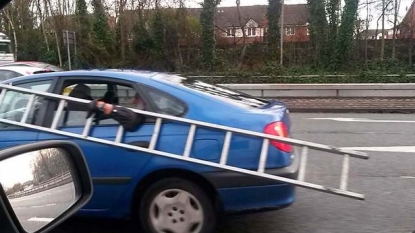 Car passengers spotted travelling with a huge metal ladder at the speed of 50mph on busy road