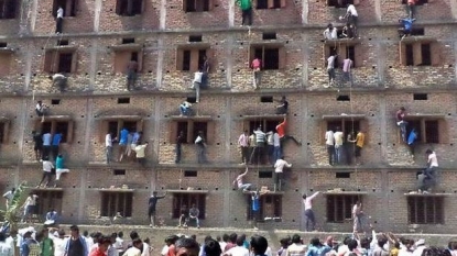 People climbs fifth floor from window to pass note to student sitting inside classroom