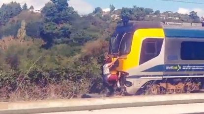 Two men risked their lives by hanging at the back of high speed train