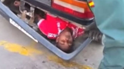 Shocking moment when border police discovered a man hiding inside car’s back bumper