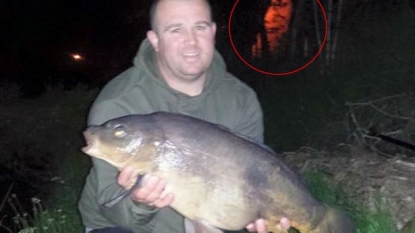 Ghost spotted in image of angler posing with his prized catch