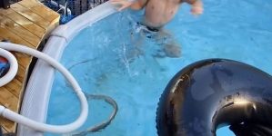 Terrifying footage shows young boys playing with huge snake in family swimming pool