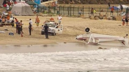 Banner-towing plane crashes on California beach and flips over; 2 injured