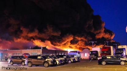 Residents evacuated by warehouse fire wait to return home as site still