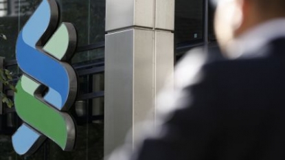 Standard Chartered reorganizes to cut costs