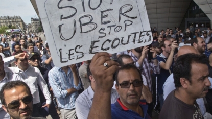 Uber halts low-cost service in France amid legal pressure