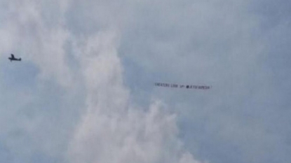 Banner calling Patriots cheaters flies over practice field