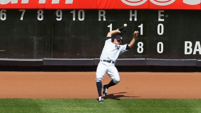 Baseball fan throws homerun ball back onto field, hitting Yankees outfielder